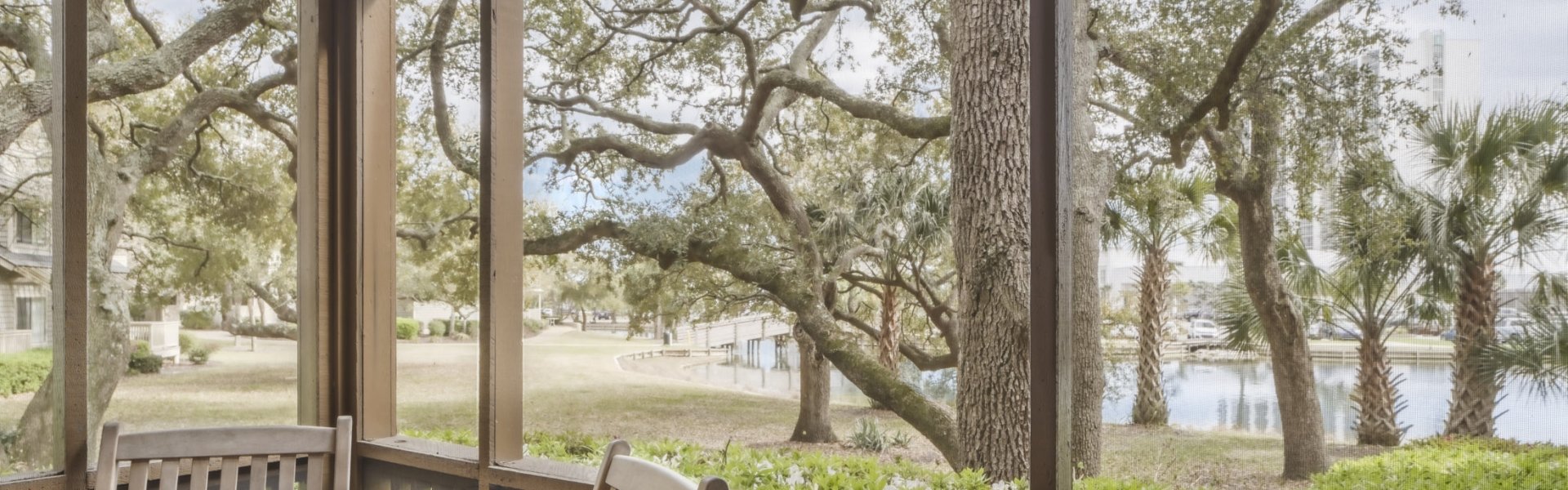 Lake View villa screened in porch with a table and chairs