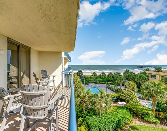 Furnished balcony overlooking ocean and resort pools