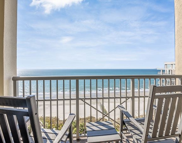 Balcony with chairs overlooking ocean