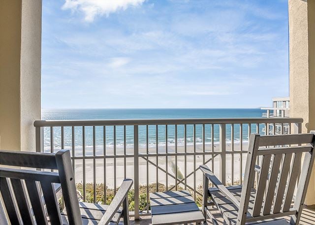 Balcony with chairs overlooking ocean