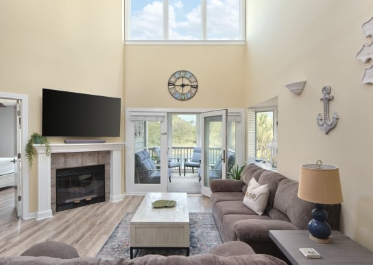 Windermere by the sea living room with patio access and a fireplace