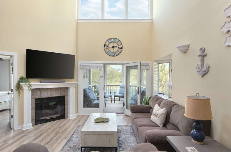Windermere by the sea living room with patio access and a fireplace