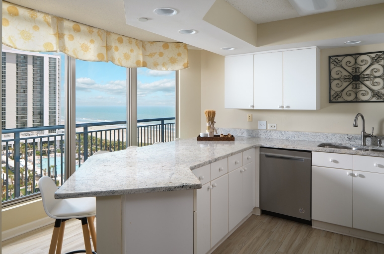 Brighton Tower kitchen with a breakfast bar and Currents Seaside Entertainment & ocean views