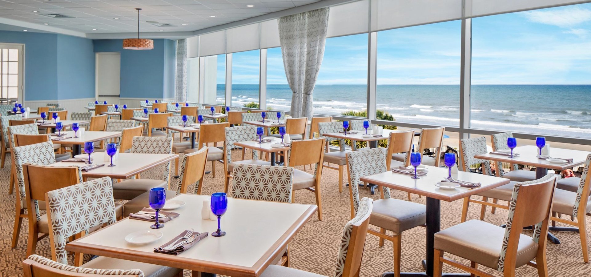 Tables and ocean view of Cafe Amalfi located at the Hilton