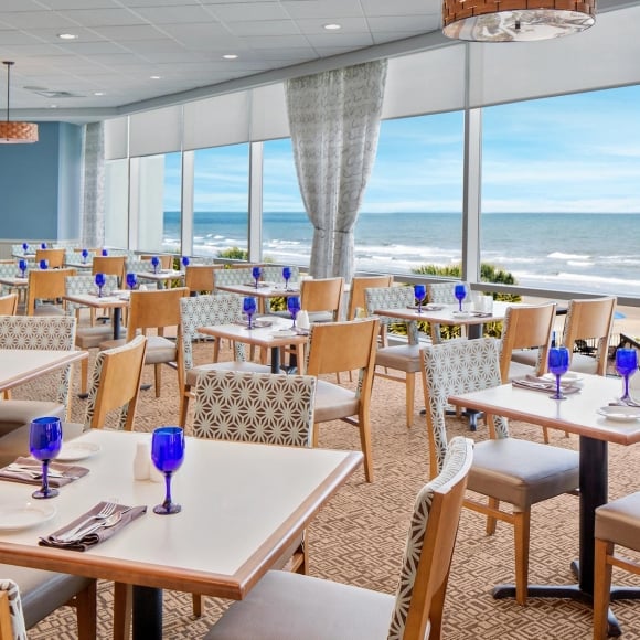 Tables and ocean view of Cafe Amalfi located at the Hilton