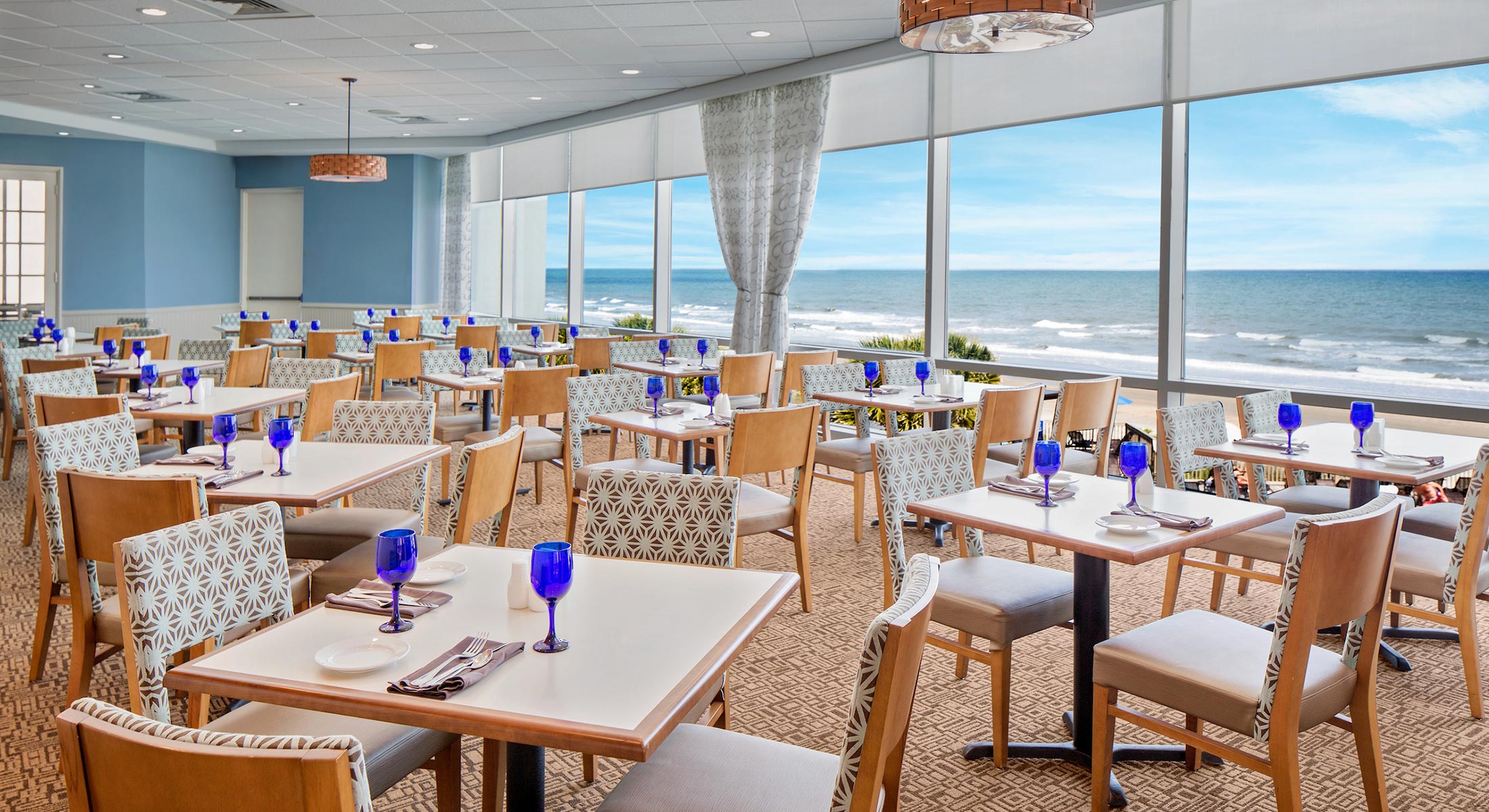 Tables and ocean view of Cafe Amalfi located at the Hilton