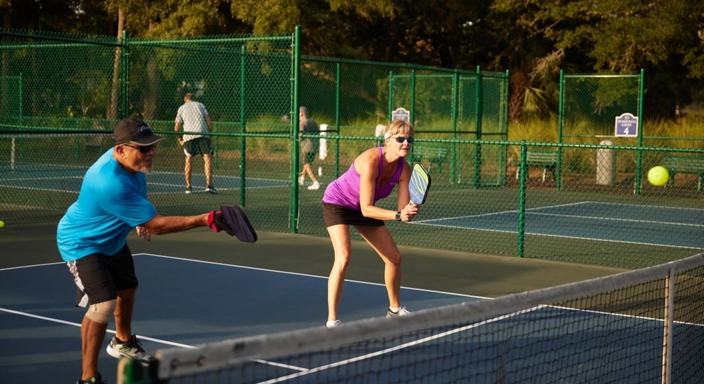 Two people playing pickleball