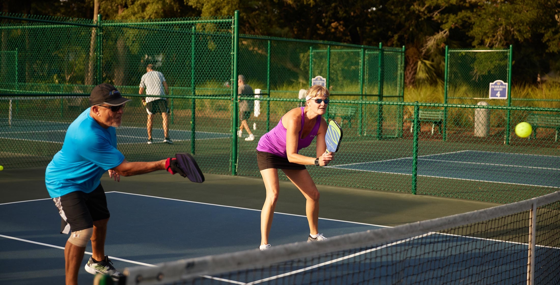 Two people playing pickleball