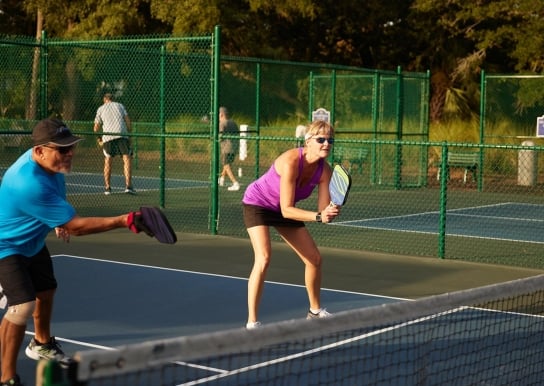 Two people playing pickleball