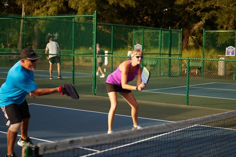 Two people playing pickleball