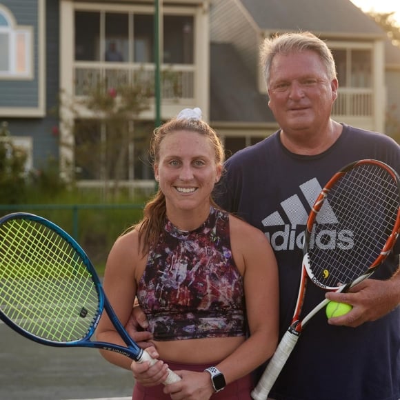 Two people holding tennis rackets