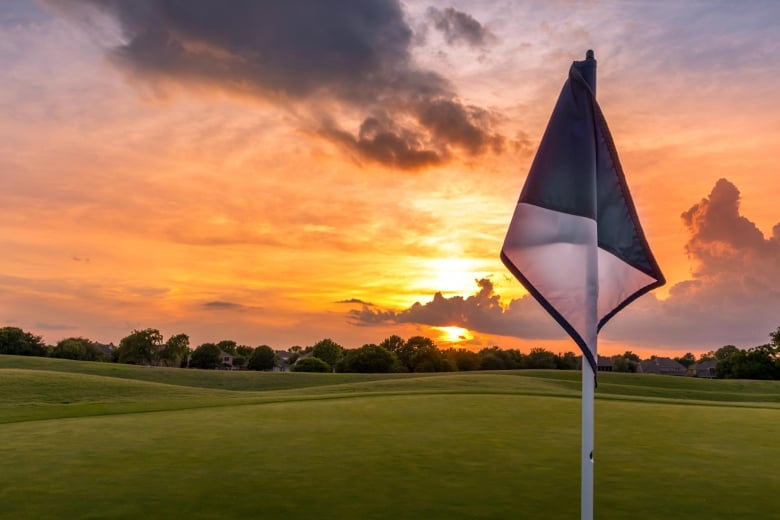 Golf flag at sunset