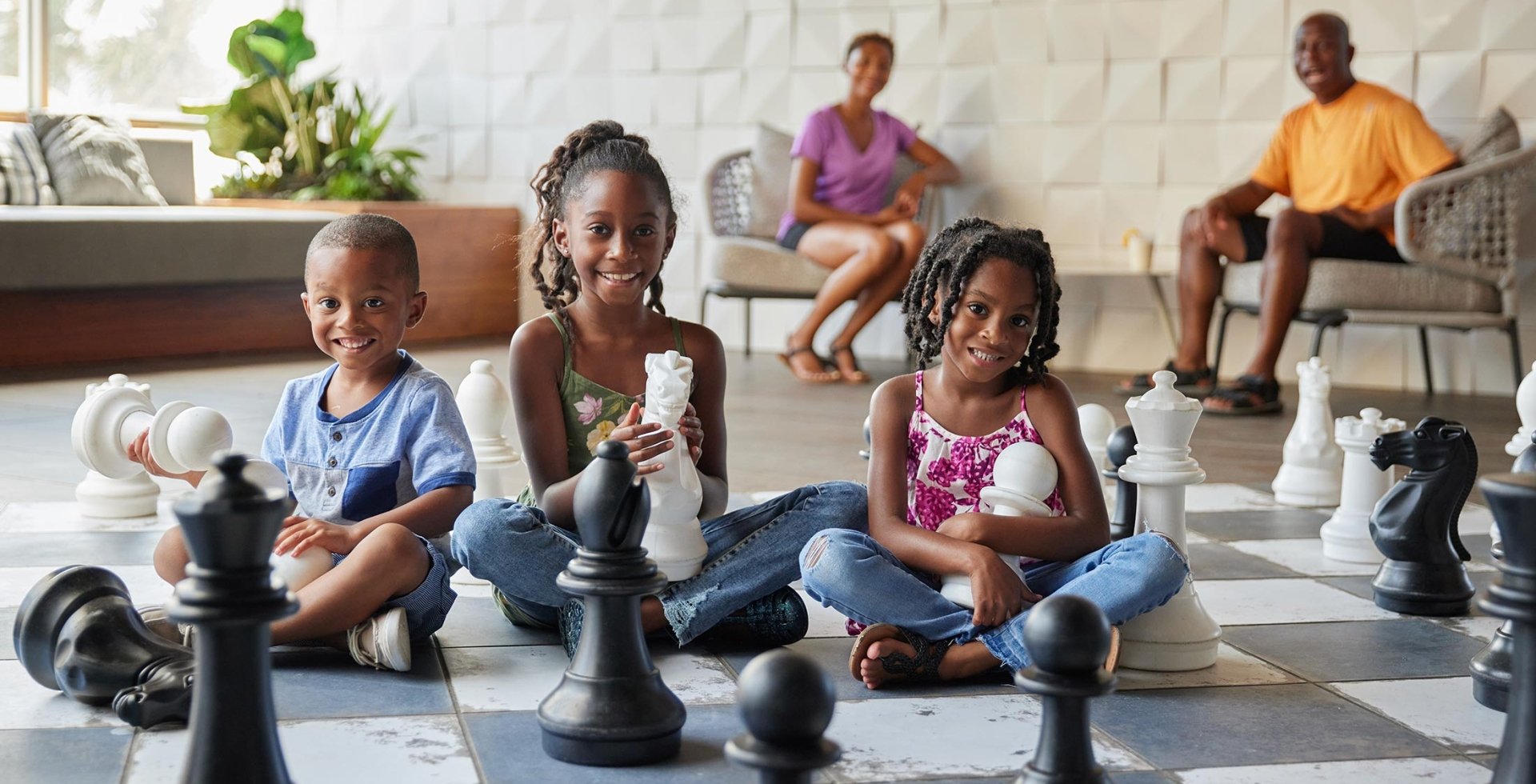 Kids playing with the giant chess set located at the Hilton