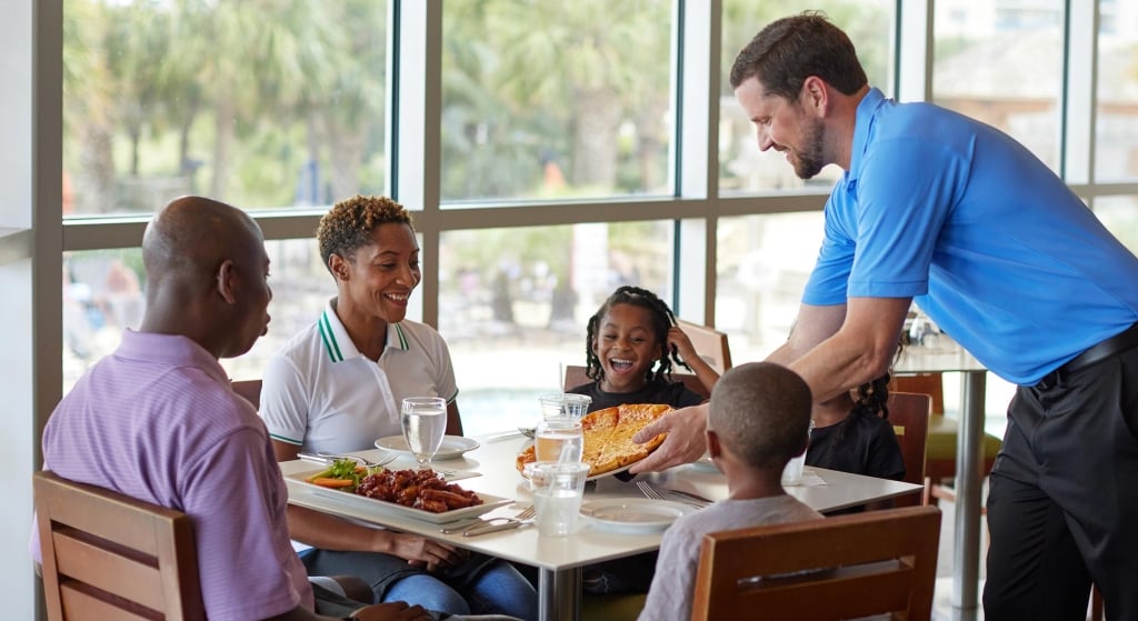 Family being served pizza