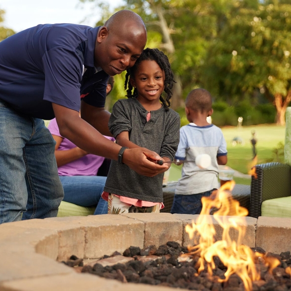 Family roasting marshmallow at fire pit