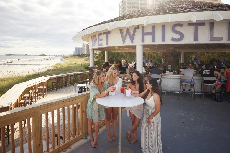 Women at table of beach bar