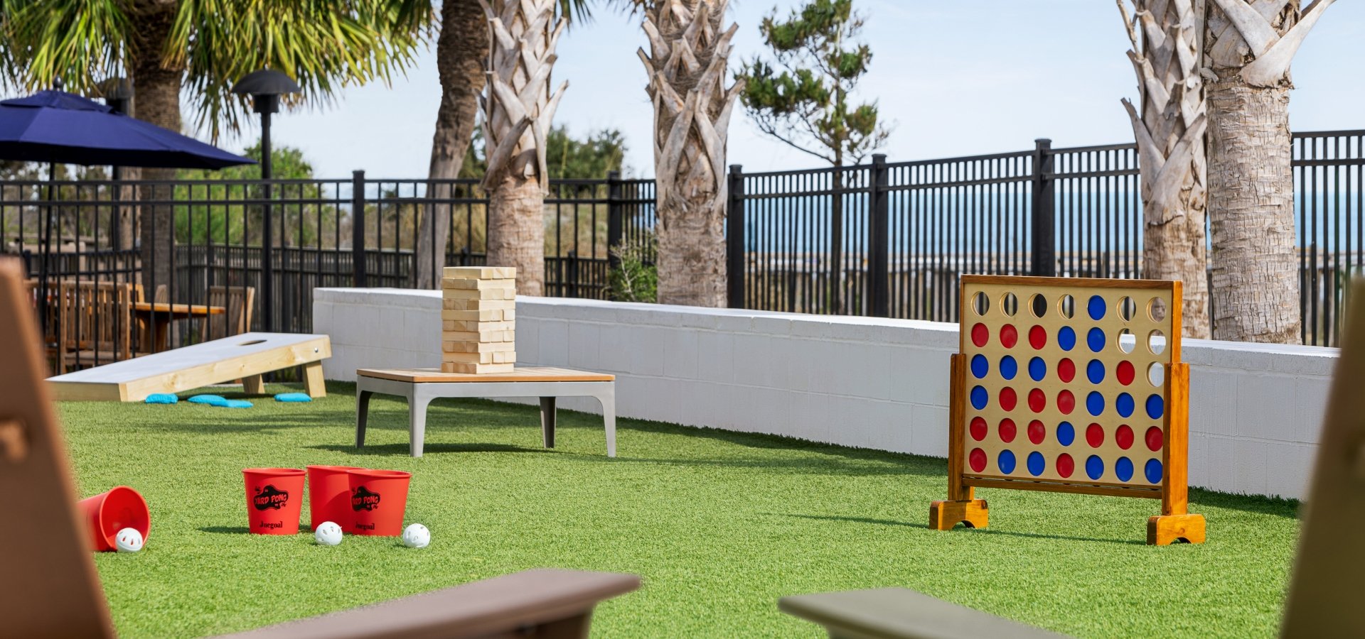 Currents Seaside Entertainment activity lawn with giant Jenga, giant connect four, and other lawn games.