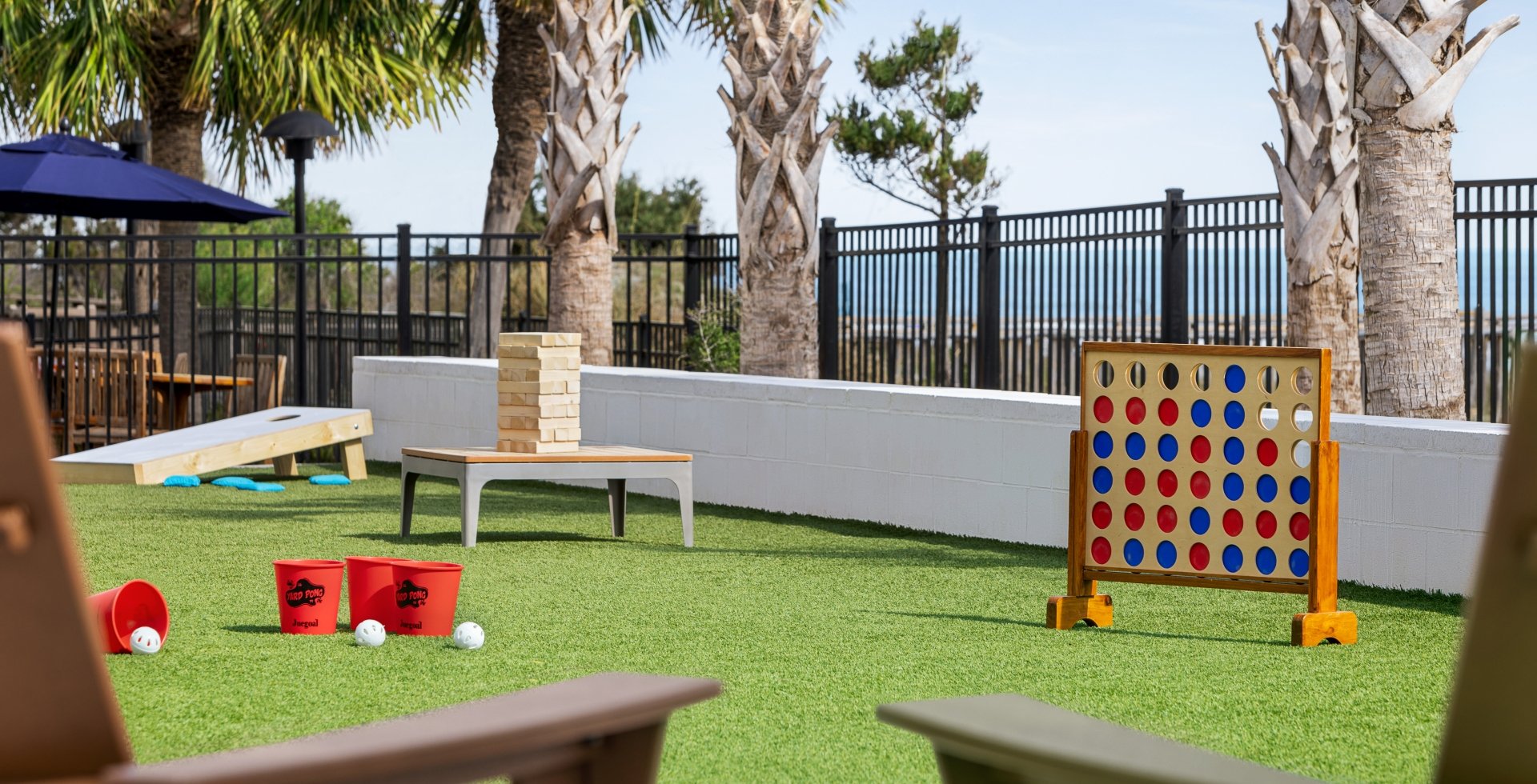 Currents Seaside Entertainment activity lawn with giant Jenga, giant connect four, and other lawn games.