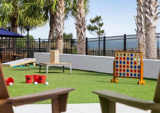 Currents Seaside Entertainment activity lawn with giant Jenga, giant connect four, and other lawn games.