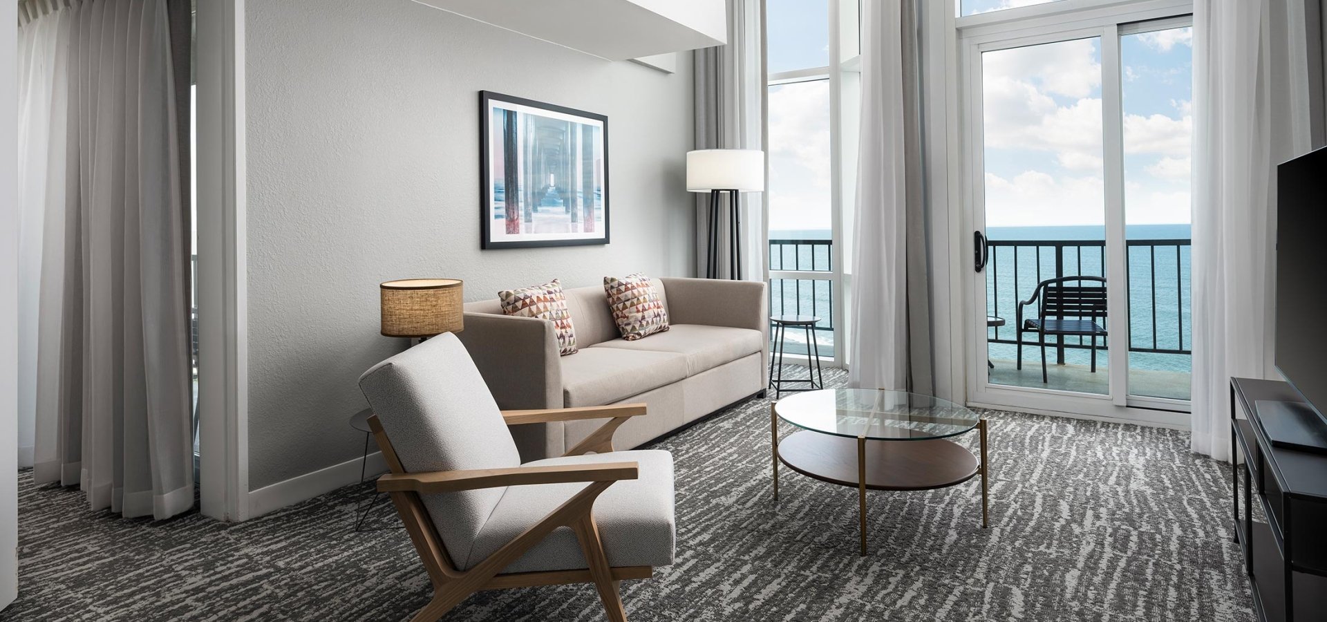 Hilton Hotel living room with ocean view balcony access