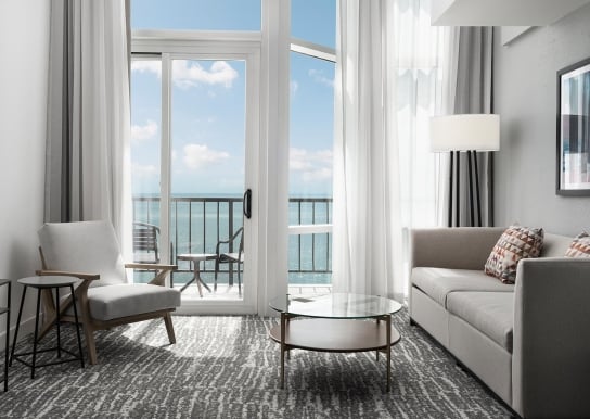 Hilton Hotel living room with ocean view balcony access