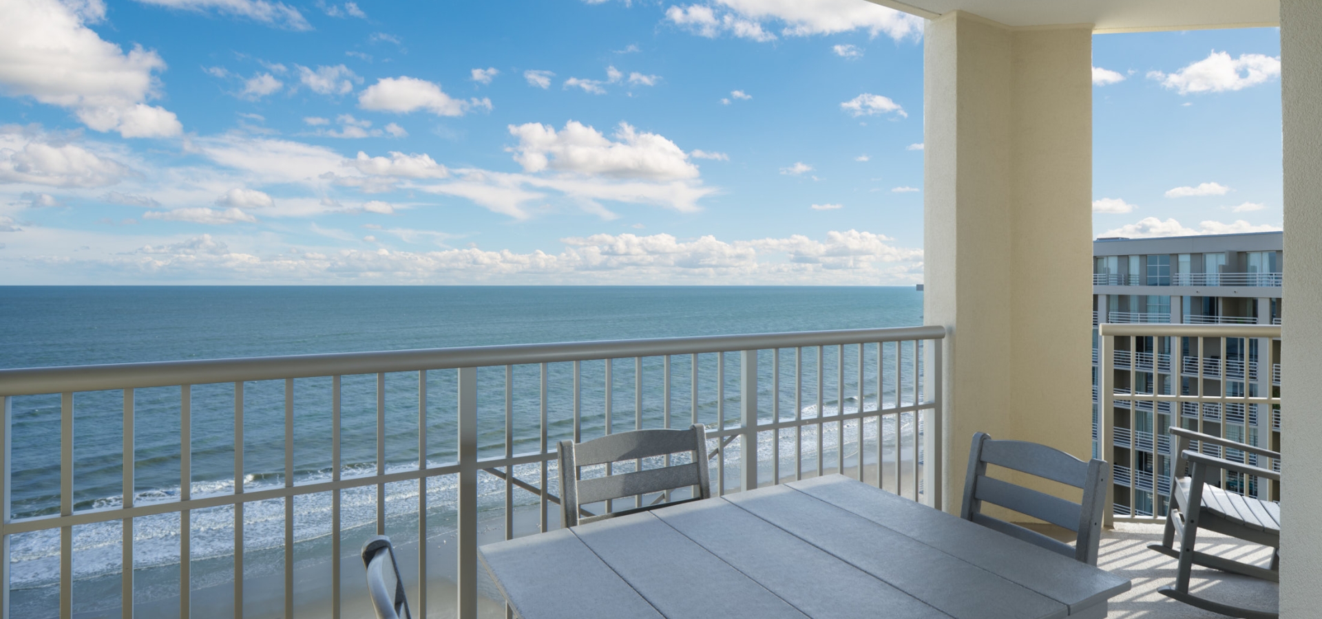 Royale Palms Oceanfront Balcony with a table and chairs