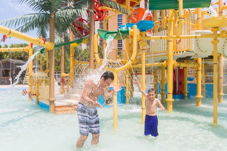 Father and son playing in water at waterpark 5