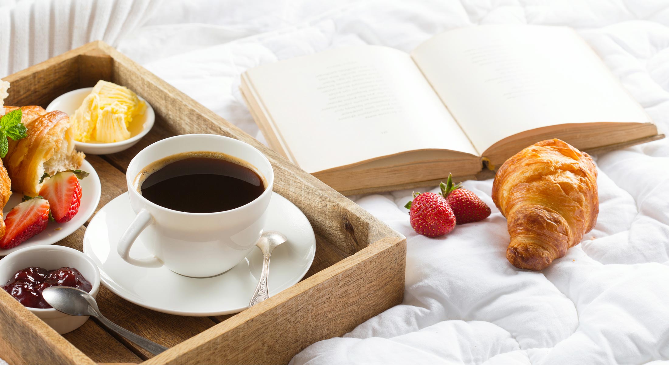 Breakfast and book on bed