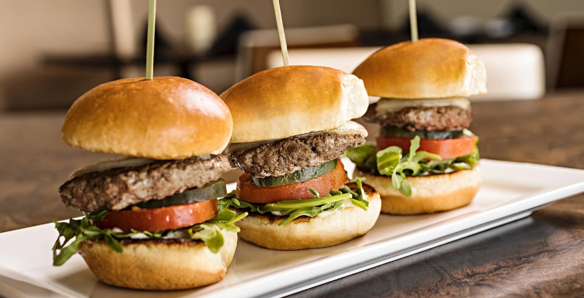 Three burger sliders on a plate