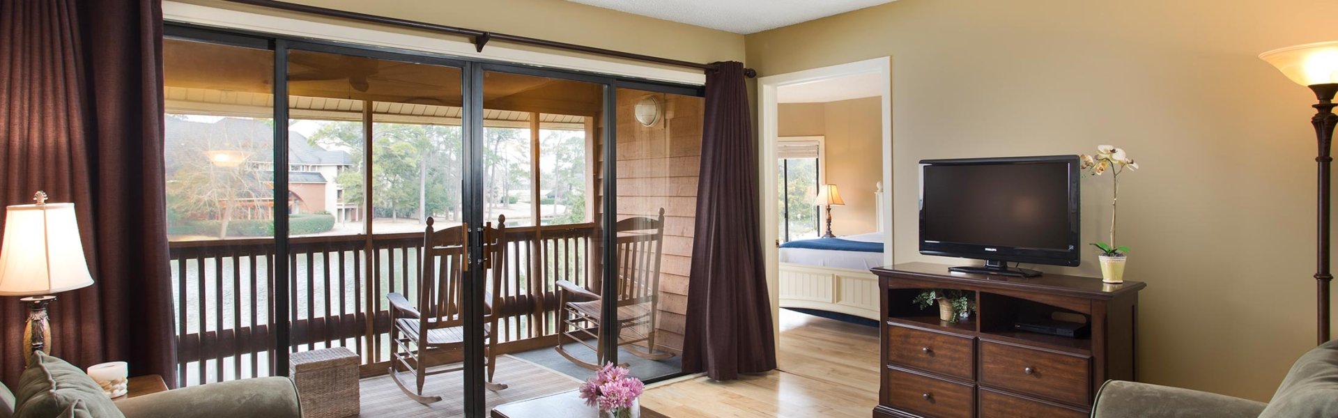 Villa living room area with a lake view screened in porch