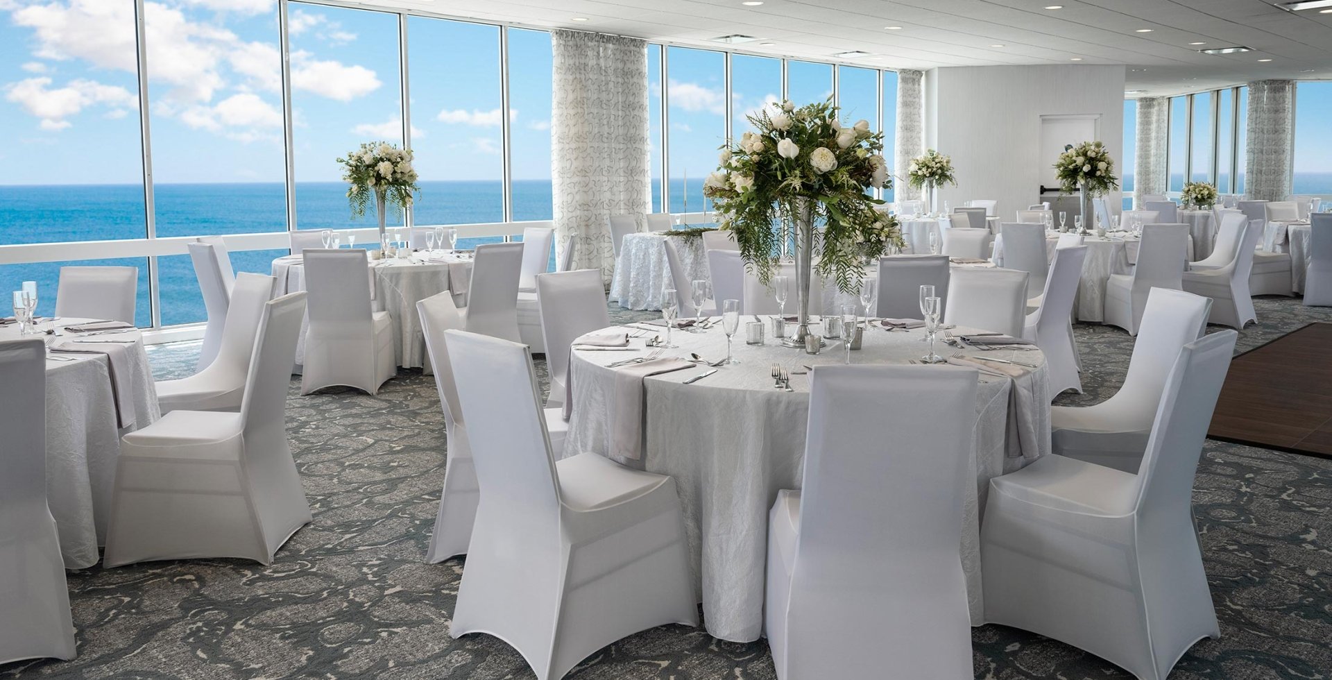 Dunes ballroom with a wedding set up with ocean views