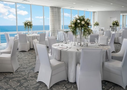 Dunes ballroom with a wedding set up with ocean views