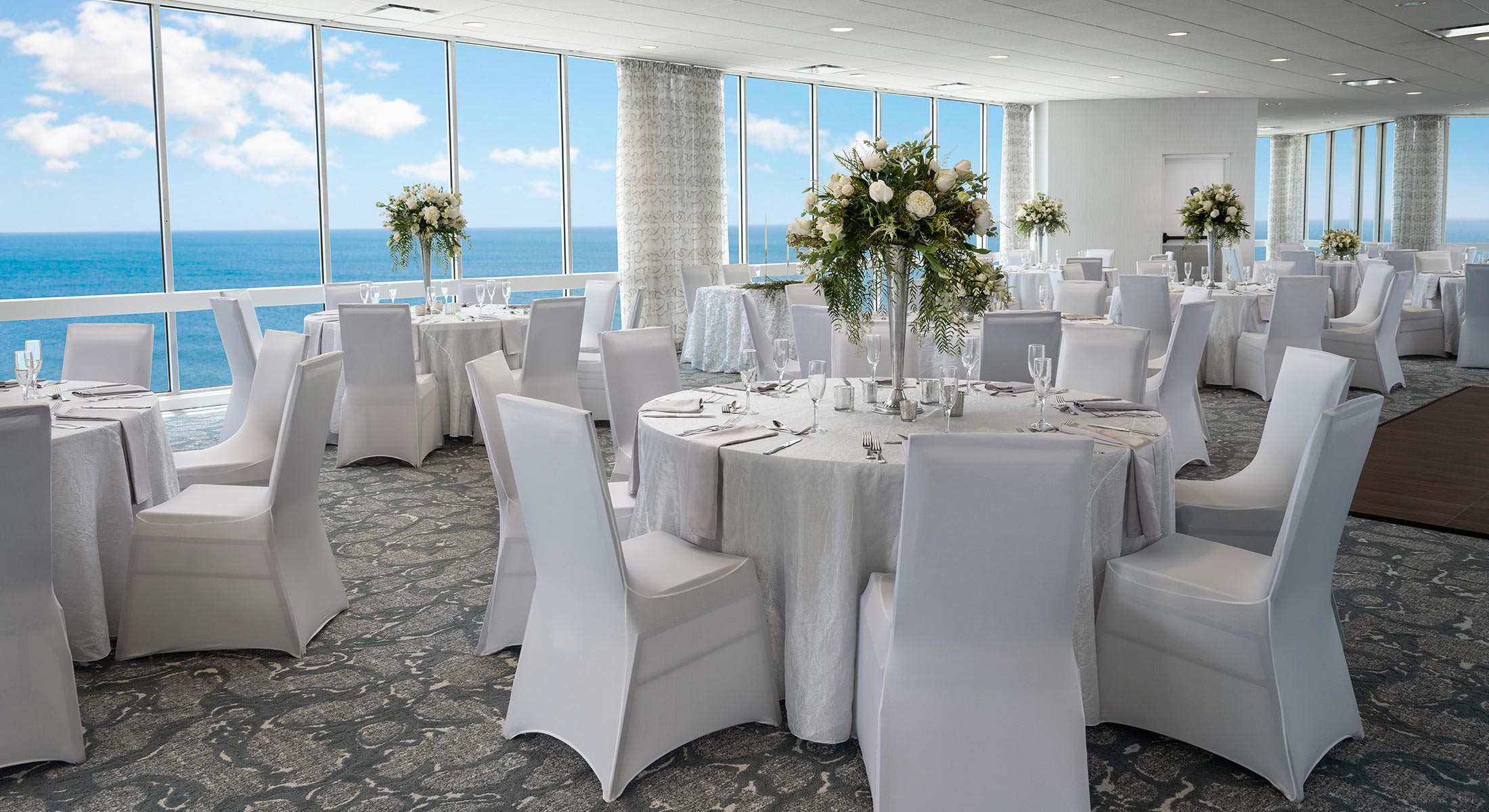 Dunes ballroom with a wedding set up with ocean views