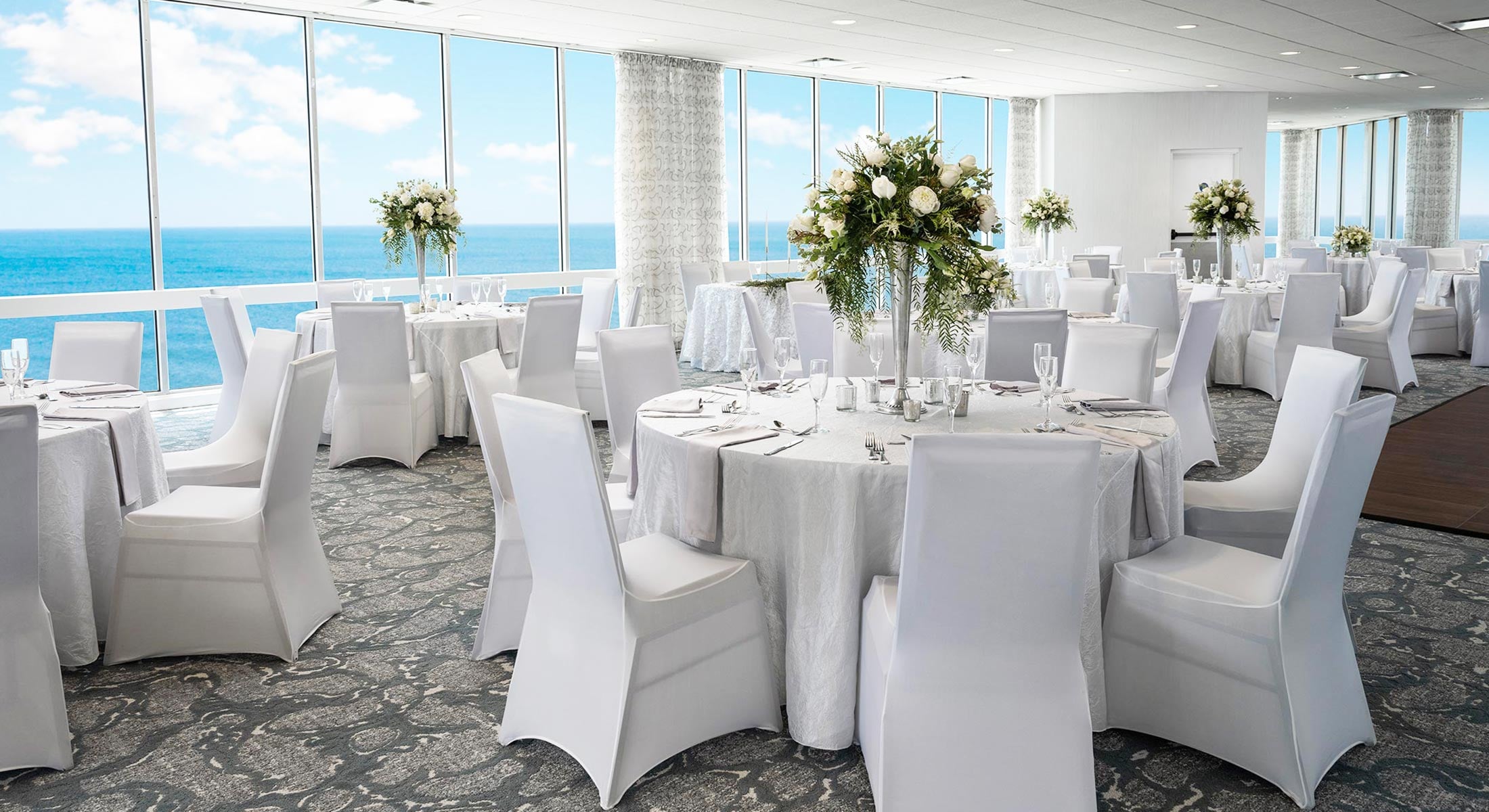 Tables set for wedding in Dunes ocean view ballroom