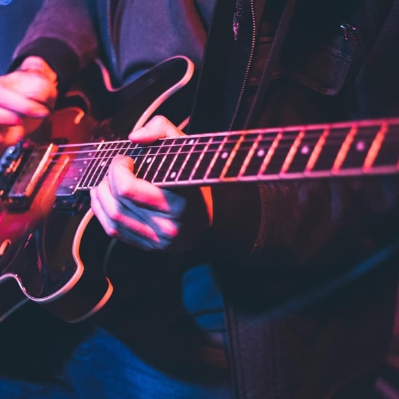 Hands playing guitar