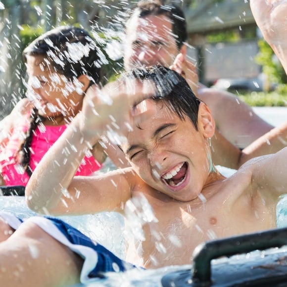 Family getting splashed at water park