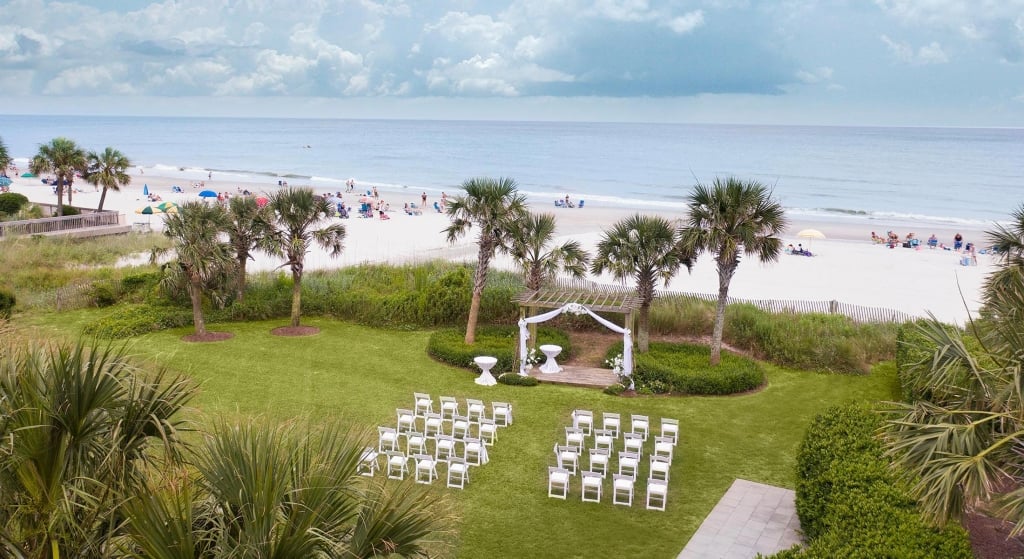 Wedding on lawn by beach