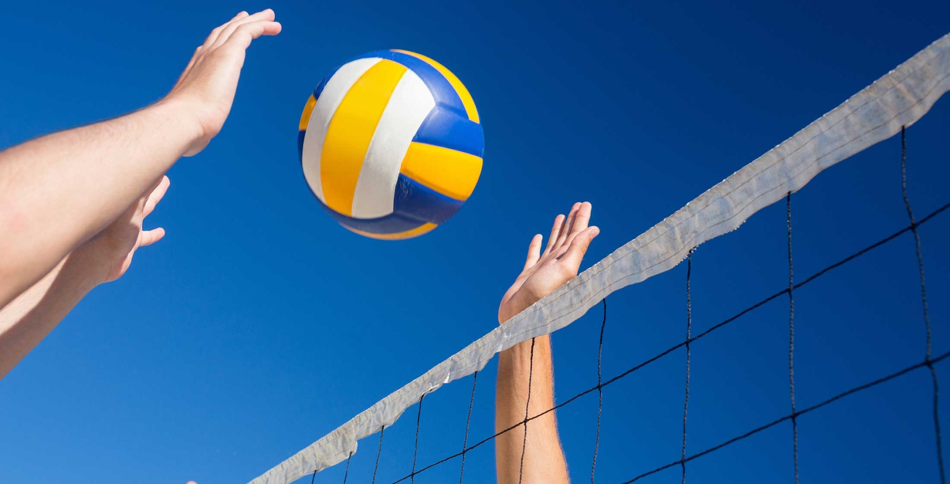 Volleyball going over net