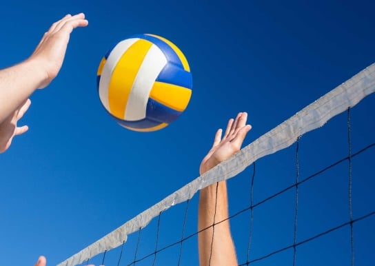 Volleyball going over net