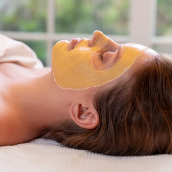 Guest with a facial mask treatment at Spa33