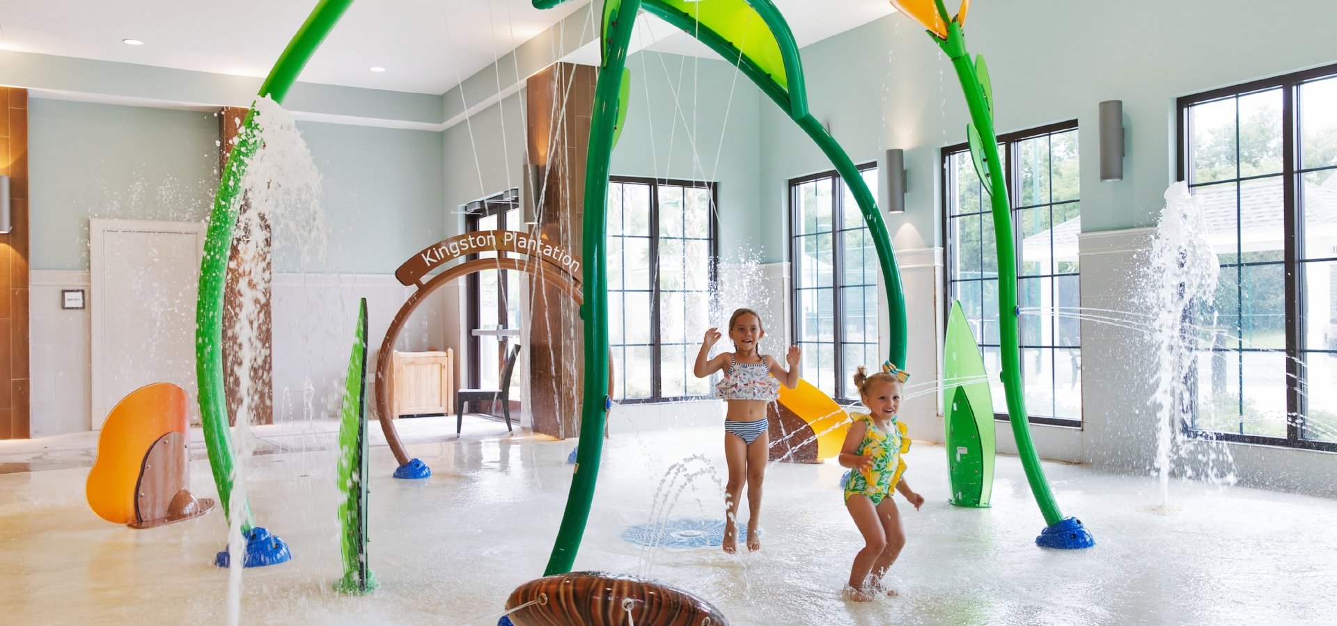 Two girls playing on the splash pad at 78Fitness