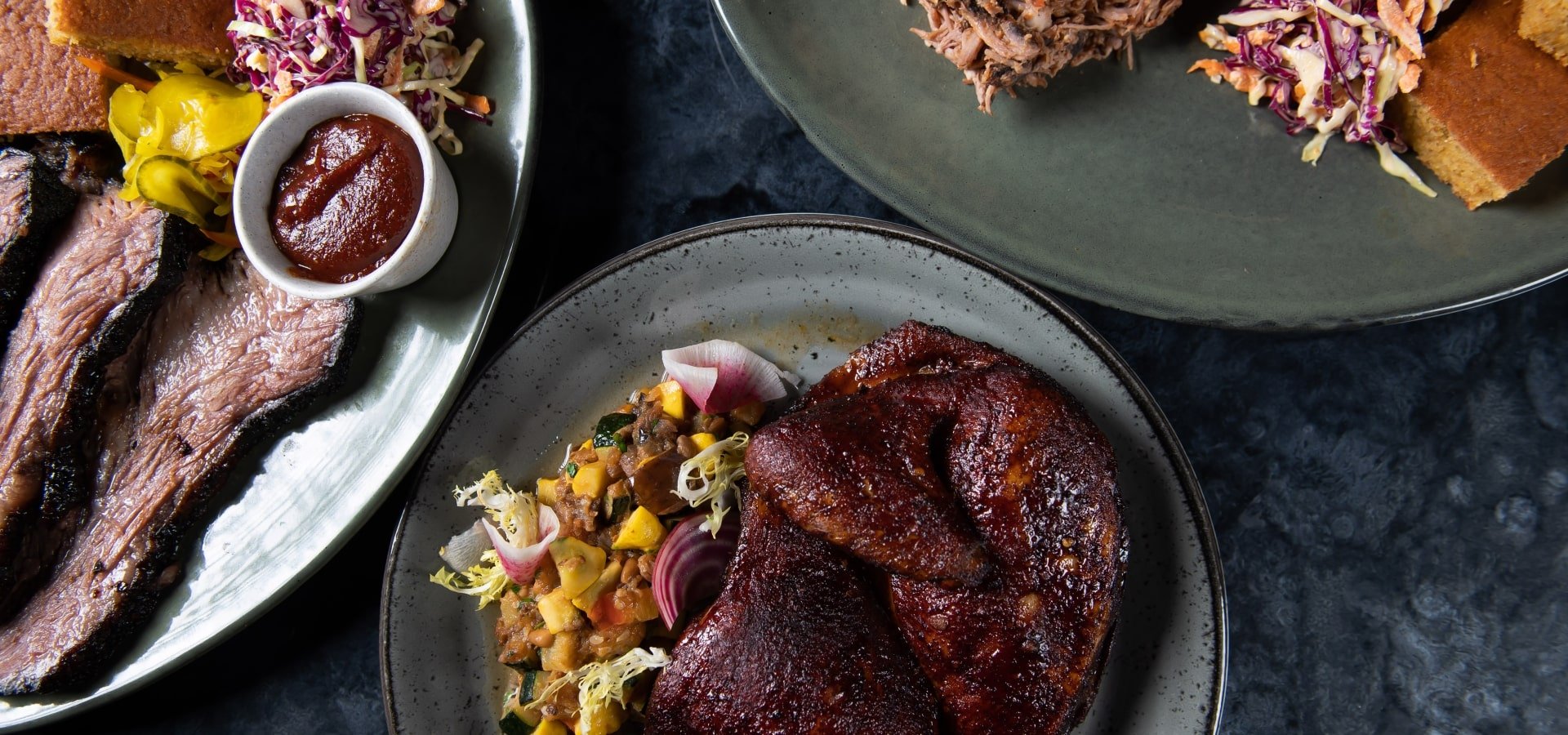 Plates of BBQ: Brisket, Pulled Pork, and Half Chicken