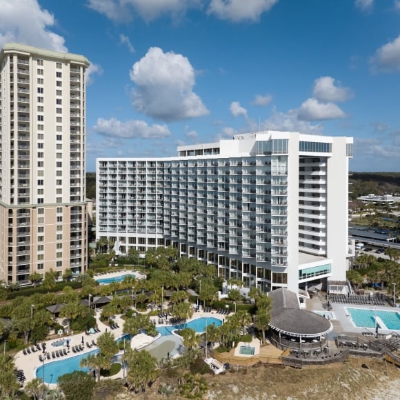 Drone view of Royale Palms and Hilton poolside exteriors