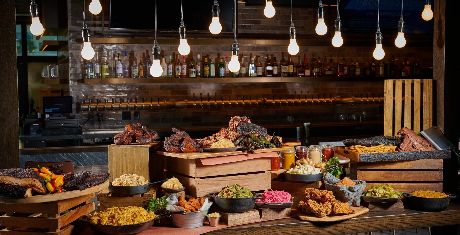 Black Drum Brewing spread of food including smoked meats, and all sides sitting in front of the bar
