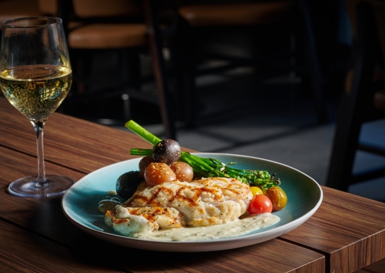 Black Drum Brewing seafood dish with asparagus, paired with white wine