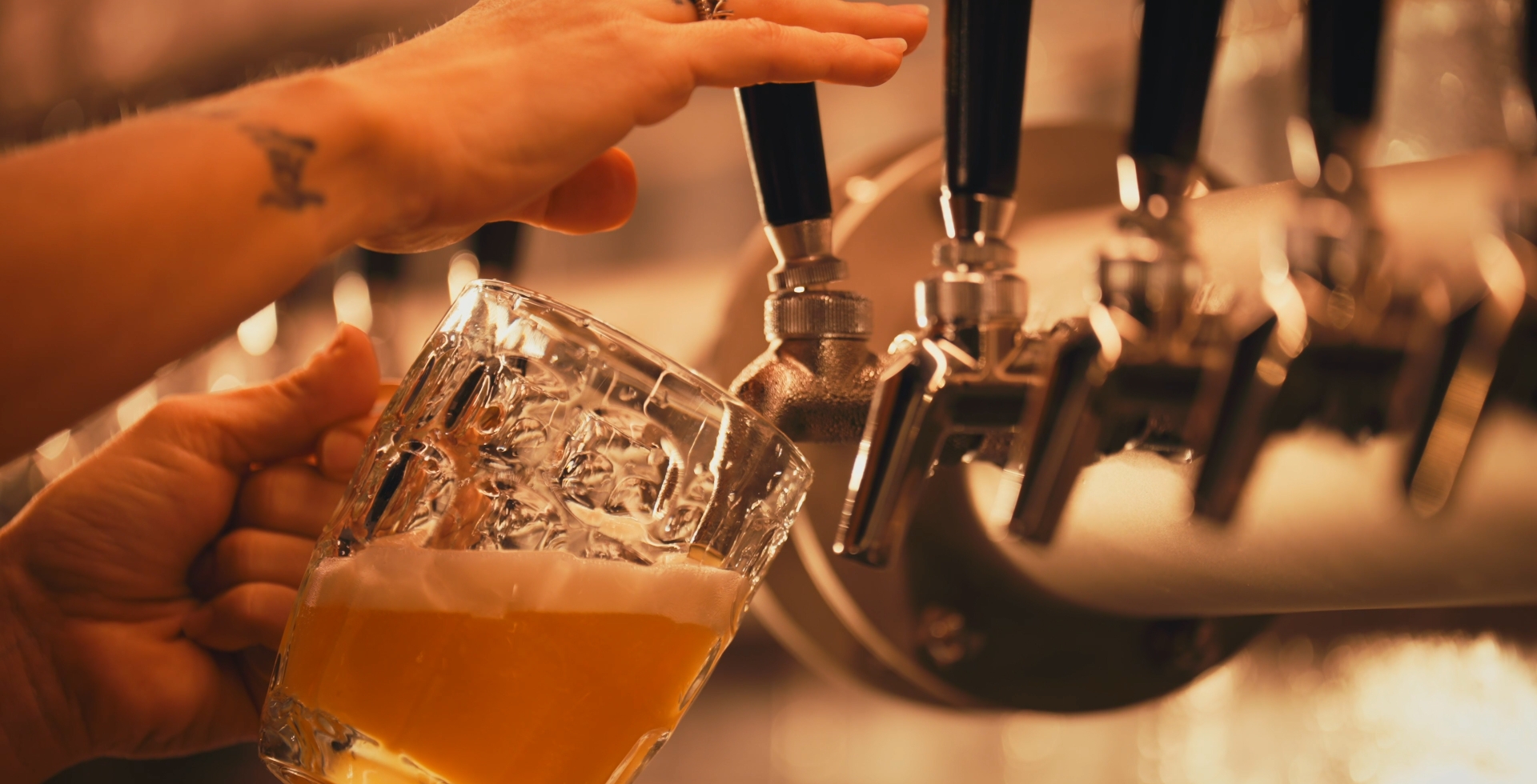 Bartender pouring a beer from a draft line