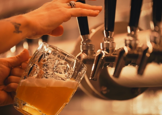 Bartender pouring a beer from a draft line