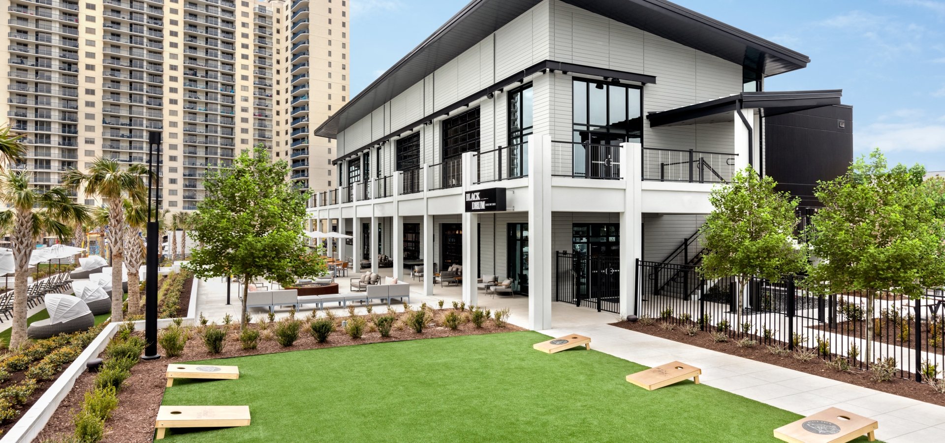 Black Drum Brewing exterior and event lawn with cornhole boards