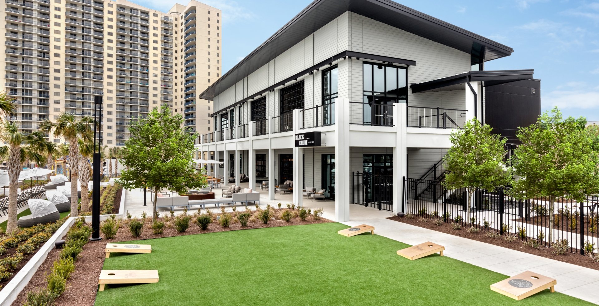 Black Drum Brewing exterior and event lawn with cornhole boards