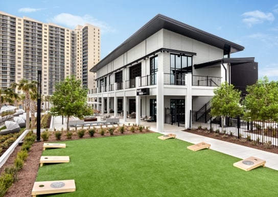 Black Drum Brewing exterior and event lawn with cornhole boards